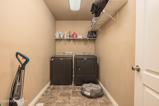 clothes washing area with separate washer and dryer