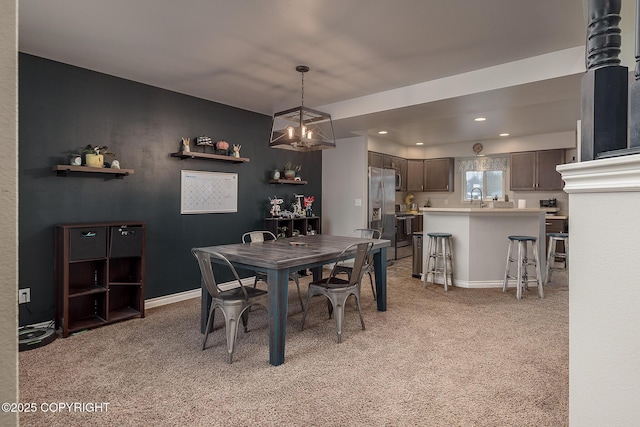 carpeted dining area featuring sink