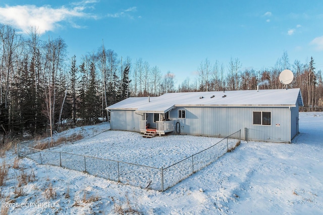 view of snow covered back of property