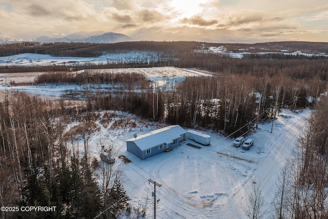 snowy aerial view with a mountain view