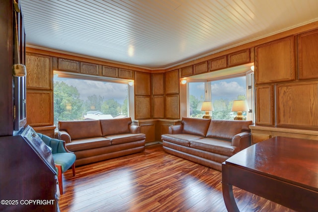 living room featuring crown molding and light hardwood / wood-style flooring