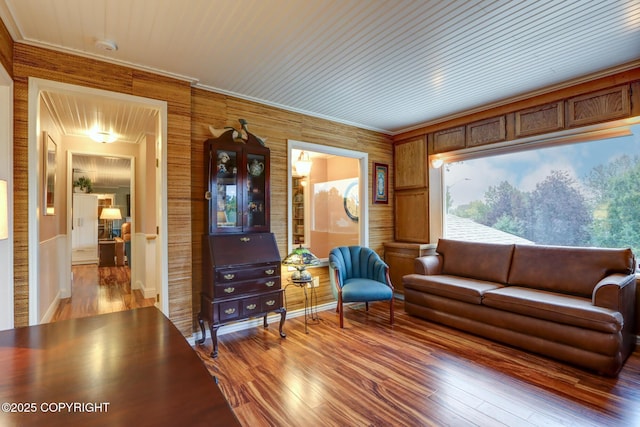 living room featuring hardwood / wood-style flooring and ornamental molding