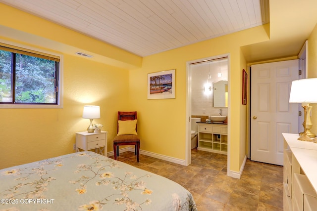 bedroom featuring sink and wooden ceiling