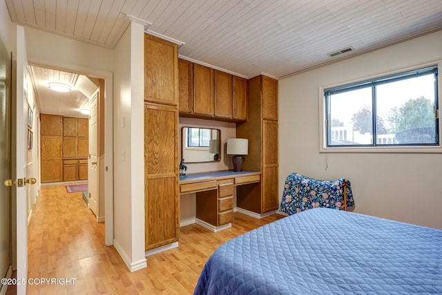 bedroom with crown molding, built in desk, light hardwood / wood-style floors, and wooden ceiling