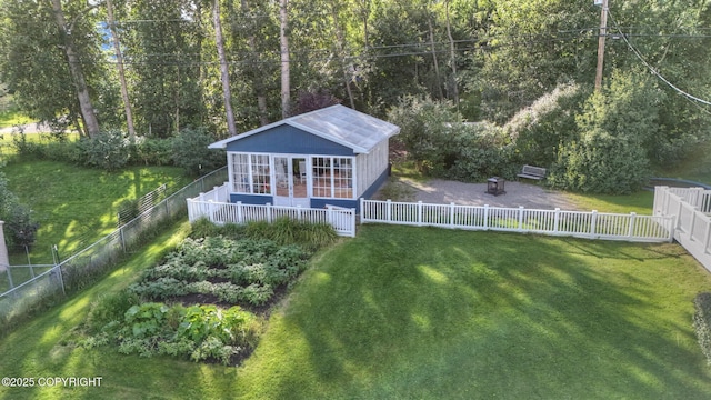 back of property featuring an outbuilding and a lawn