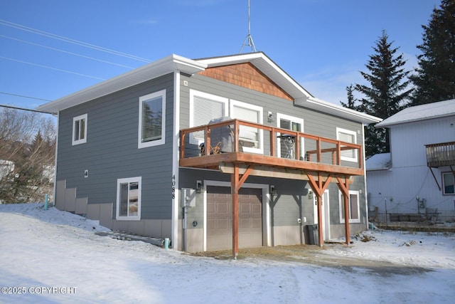 exterior space featuring a garage and a balcony