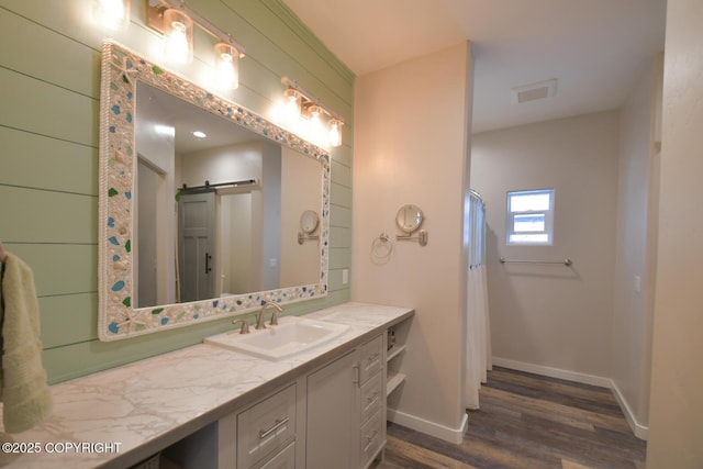 bathroom with vanity and hardwood / wood-style floors