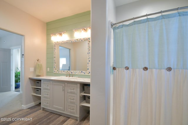 bathroom with wood-type flooring, a shower with shower curtain, and vanity