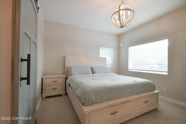 bedroom featuring an inviting chandelier and light colored carpet