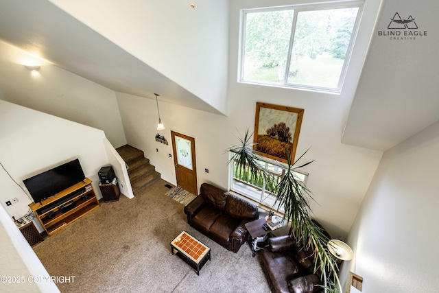6976 W Windsor Dr, Wasilla, AK 99623 - carpeted living room with a high ceiling and stairs