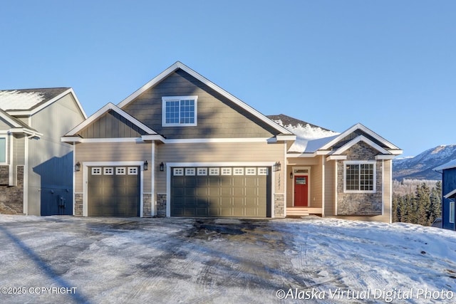 craftsman-style home with a garage and a mountain view