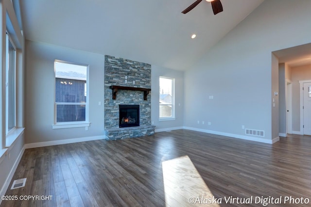 unfurnished living room featuring a fireplace, high vaulted ceiling, dark hardwood / wood-style floors, and ceiling fan