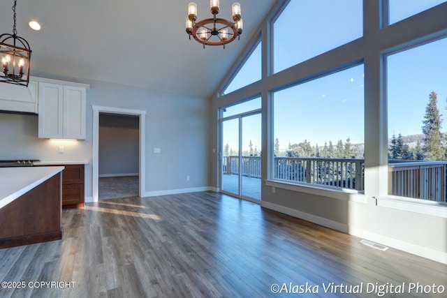 kitchen with an inviting chandelier, white cabinetry, decorative light fixtures, and dark hardwood / wood-style flooring