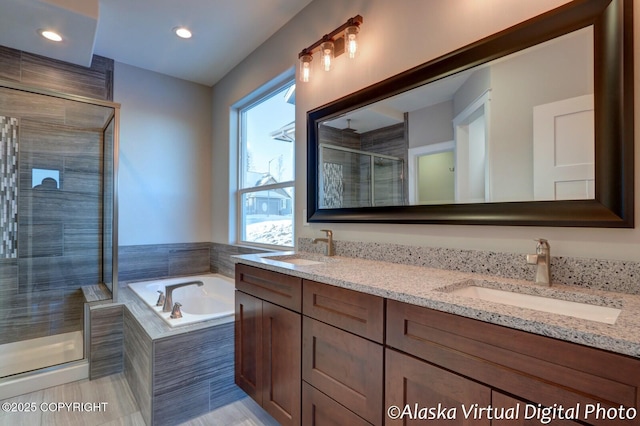 bathroom featuring plus walk in shower and vanity