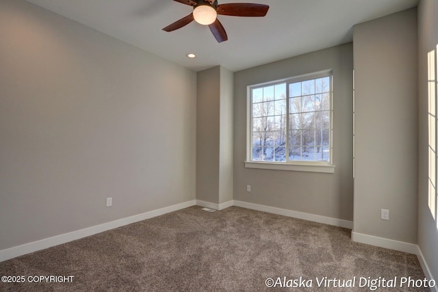 carpeted empty room featuring ceiling fan