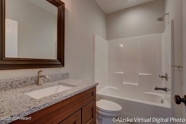 full bathroom featuring vanity, bathing tub / shower combination, and toilet