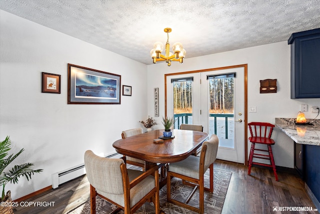 dining area featuring a baseboard heating unit, dark wood-type flooring, a textured ceiling, and an inviting chandelier