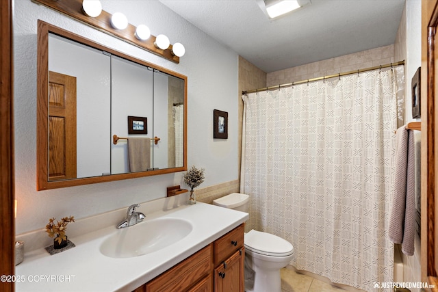 bathroom with tile patterned flooring, vanity, walk in shower, and toilet