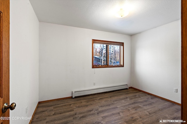 unfurnished room with baseboard heating, dark hardwood / wood-style floors, and a textured ceiling