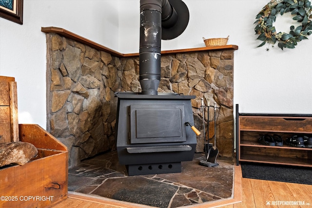 details featuring hardwood / wood-style flooring and a wood stove