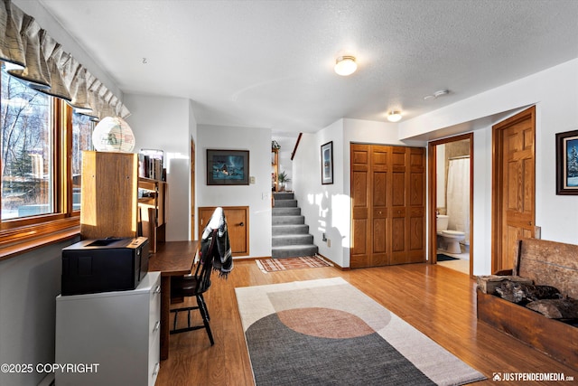 interior space with hardwood / wood-style floors and a textured ceiling