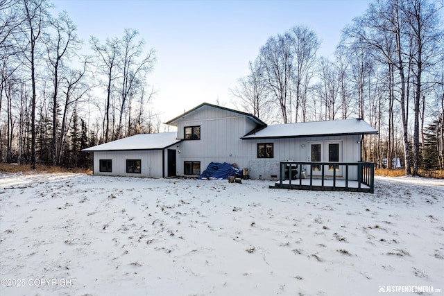 snow covered property featuring a deck