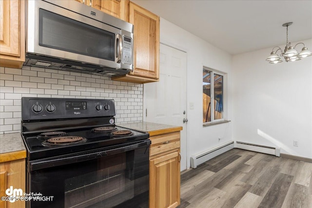 kitchen with dark wood finished floors, light countertops, stainless steel microwave, electric range, and decorative backsplash