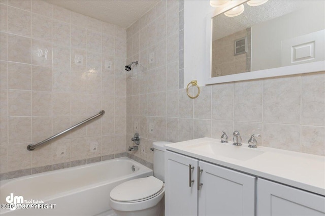 bathroom with tile walls, shower / bathtub combination, toilet, vanity, and a textured ceiling