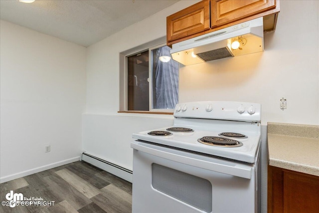 kitchen with under cabinet range hood, a baseboard heating unit, dark wood-type flooring, brown cabinetry, and white electric range oven