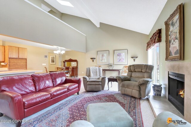 living area featuring a notable chandelier, high vaulted ceiling, a tiled fireplace, and beamed ceiling