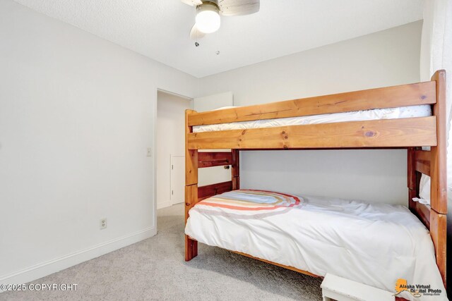 bedroom with a ceiling fan, carpet, and baseboards