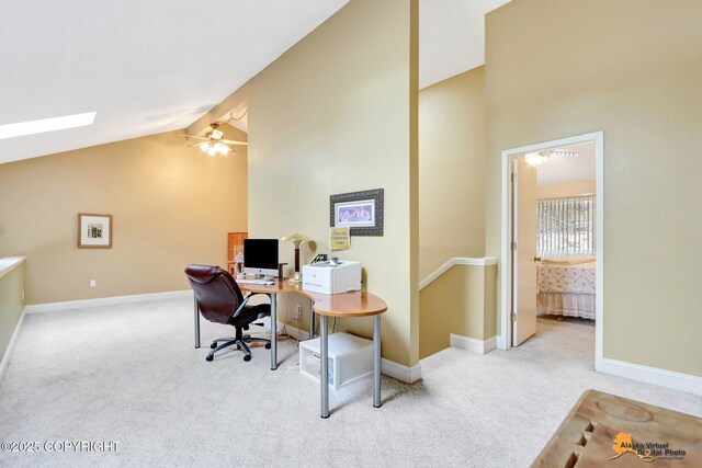 office featuring a ceiling fan, light colored carpet, high vaulted ceiling, and baseboards