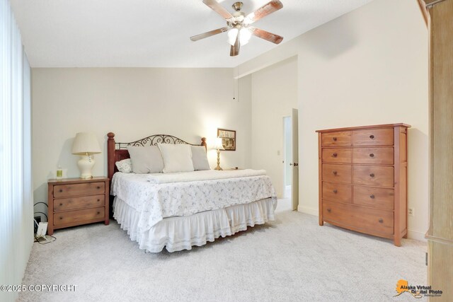 bedroom with a ceiling fan, lofted ceiling, light colored carpet, and baseboards