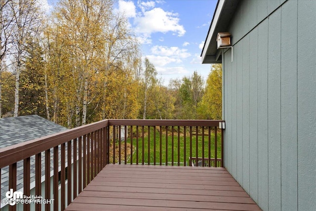 wooden terrace featuring a yard