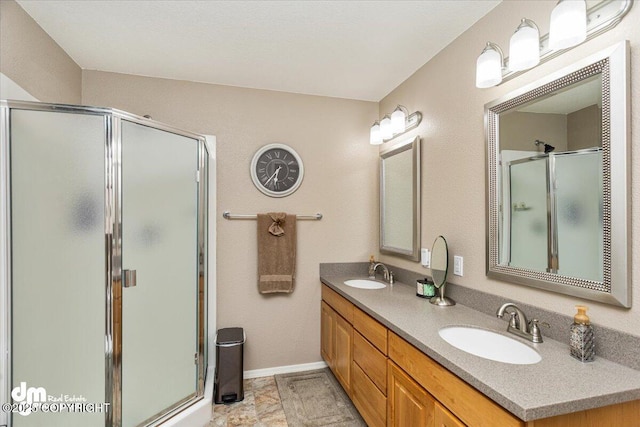 bathroom featuring vanity and a shower with door