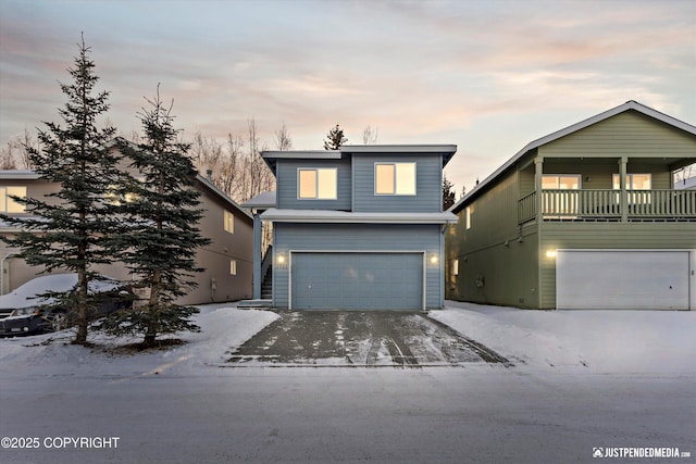 view of property with a balcony and a garage