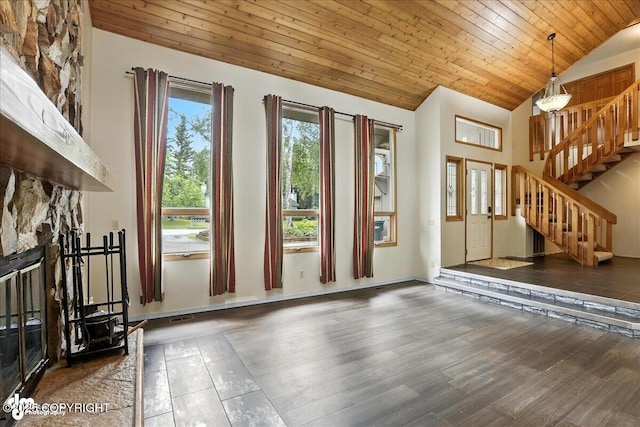 2629 Legacy Dr, Anchorage, AK 99516 - unfurnished living room with vaulted ceiling, stairway, wood ceiling, wood finished floors, and a stone fireplace