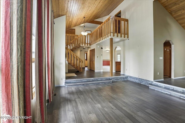 2629 Legacy Dr, Anchorage, AK 99516 - unfurnished living room featuring arched walkways, wooden ceiling, a chandelier, high vaulted ceiling, and wood finished floors