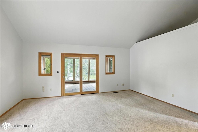 2629 Legacy Dr, Anchorage, AK 99516 - spare room featuring light colored carpet and vaulted ceiling