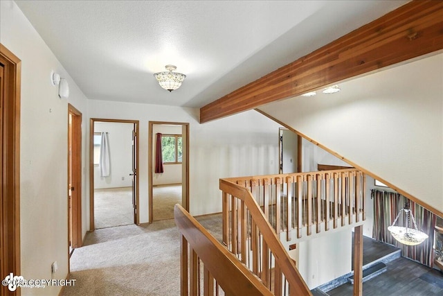 2629 Legacy Dr, Anchorage, AK 99516 - hall featuring an upstairs landing, carpet floors, and beam ceiling