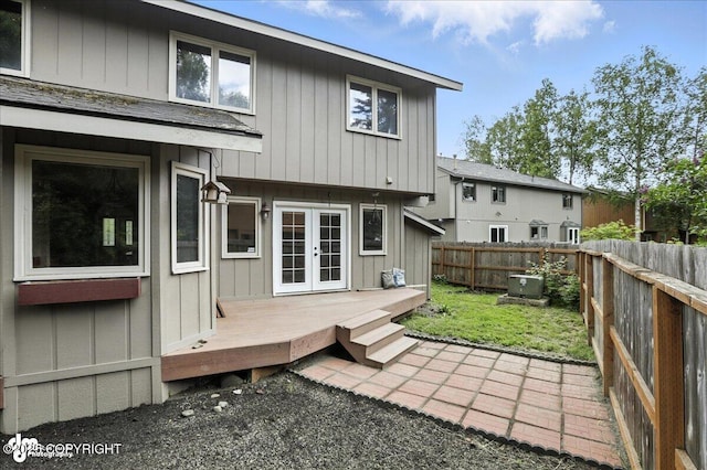 2629 Legacy Dr, Anchorage, AK 99516 - back of house with french doors, a fenced backyard, a wooden deck, and board and batten siding