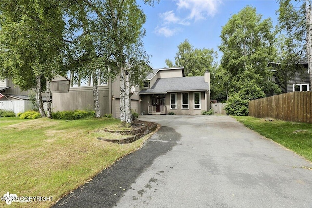 2629 Legacy Dr, Anchorage, AK 99516 - view of front of house with asphalt driveway, a chimney, and a garage