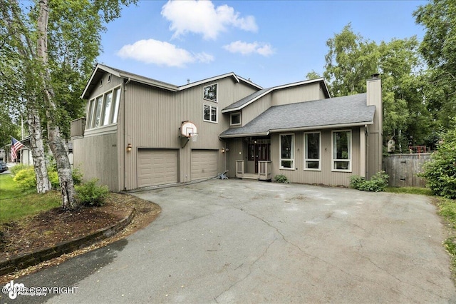 2629 Legacy Dr, Anchorage, AK 99516 - view of front of property with driveway, a chimney, and an attached garage