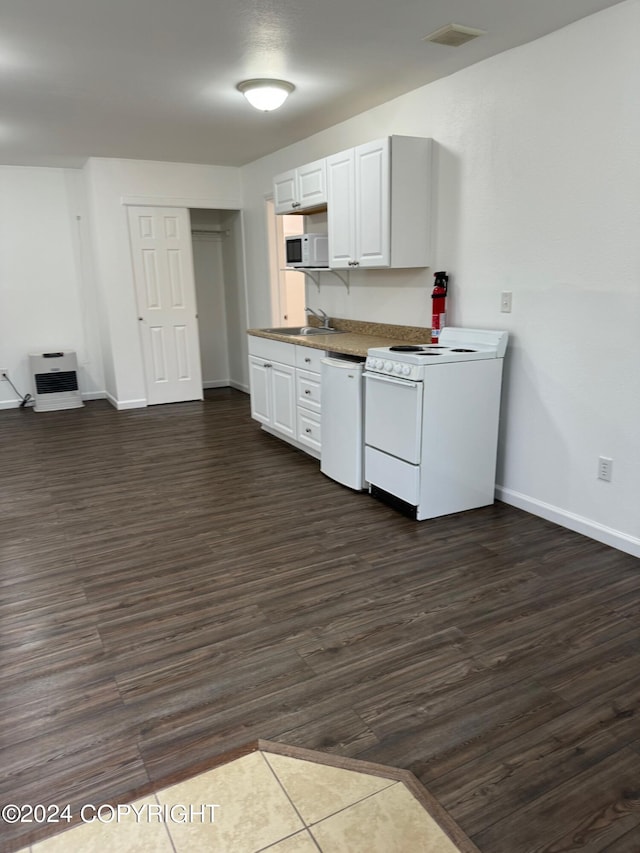 kitchen with dark hardwood / wood-style flooring, heating unit, white cabinets, and white appliances