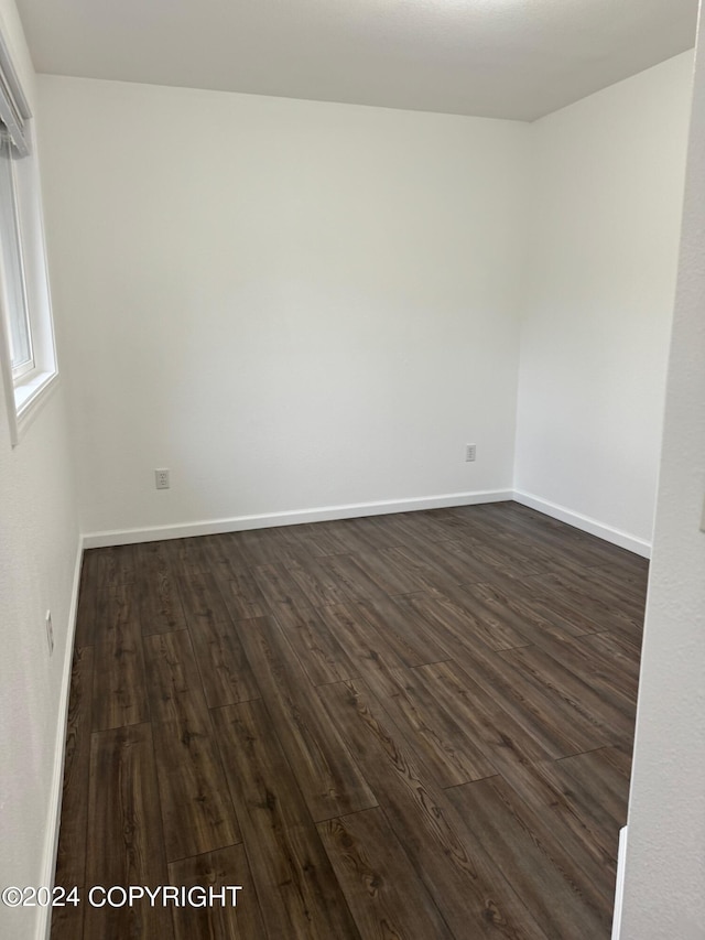 spare room with dark hardwood / wood-style floors