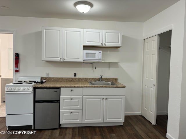 kitchen with white cabinetry, white appliances, dark hardwood / wood-style flooring, and sink