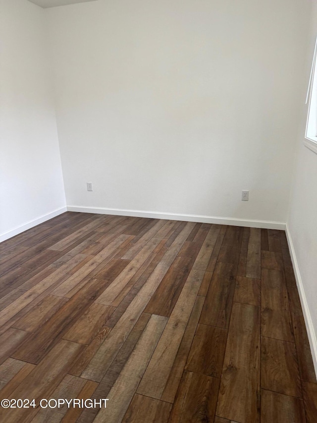 empty room with dark hardwood / wood-style floors