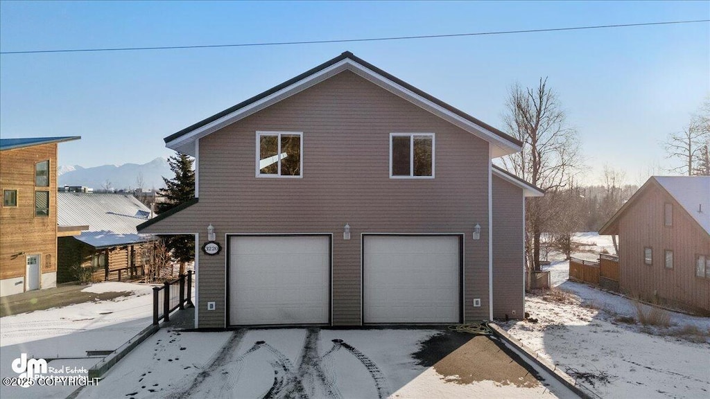 exterior space with a garage and a mountain view