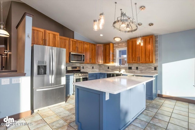 kitchen featuring pendant lighting, appliances with stainless steel finishes, and a kitchen island