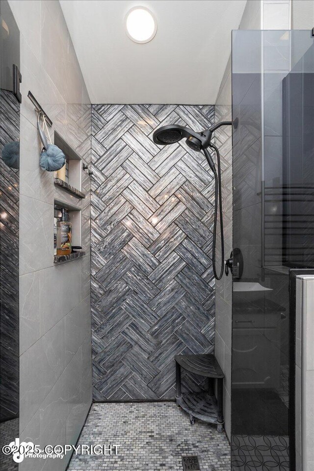 bathroom with a tile shower